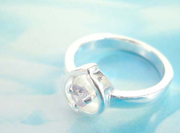 925. stamped silver ring with fire pattern holding clear rhinestone design