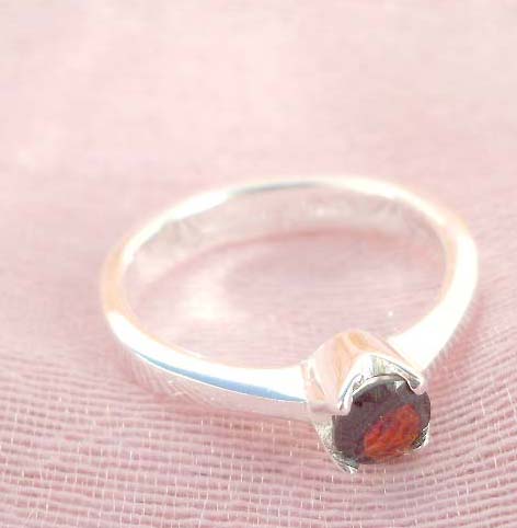 925. stamped silver ring with a round ruby cubic zirconia design