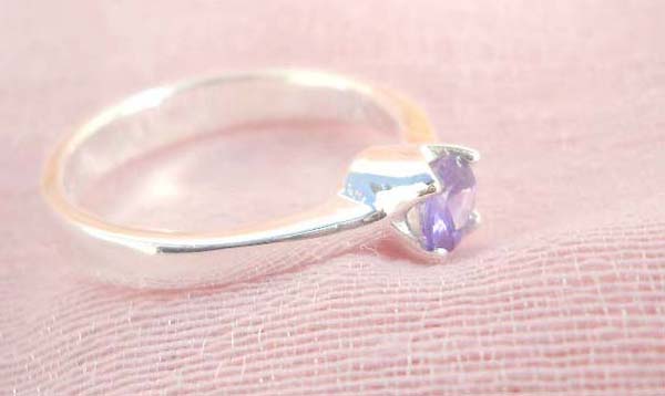 925. stamped silver ring with a round purple cubic zirconia design