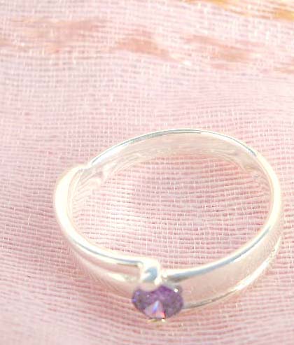 925. stamped silver ring with thick band holding a purple design